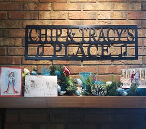 a picture of our fireplace mantel with christmas cards and garland and our metal lazar cut sign that reads chip and tracy's place